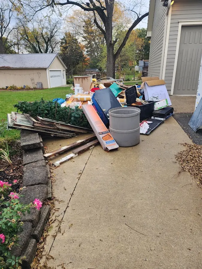 Dumpster being loaded with debris for 12 Yard Dumpster Rental in Big Bear Lake